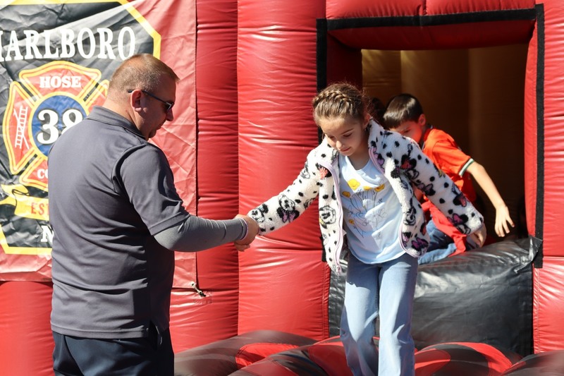 A student gets assistance from  a firefighter