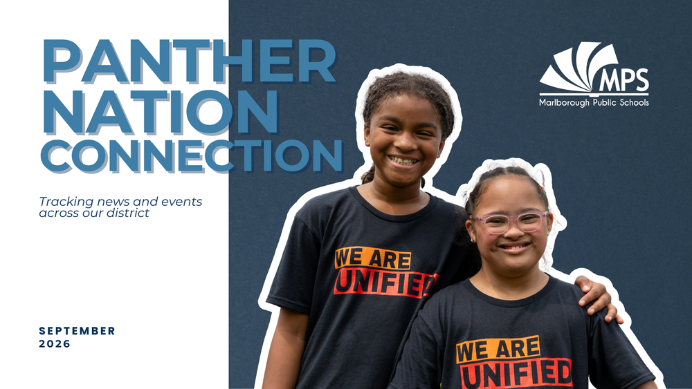 Two smiling elementary-age girls stand together against a dark blue background, both wearing black 'We Are Unified' t-shirts, with the MPS Marlborough Public Schools logo in the upper right.