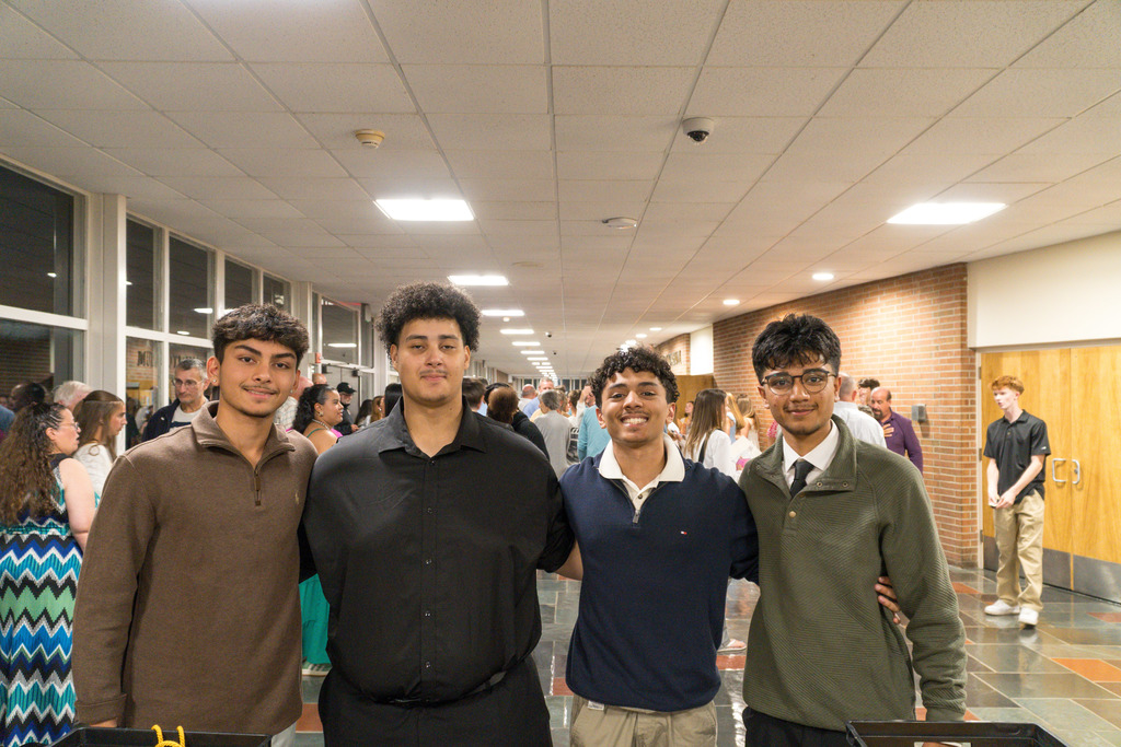 Four NHS members pose for a group photo outside the Whitcomb auditorium.