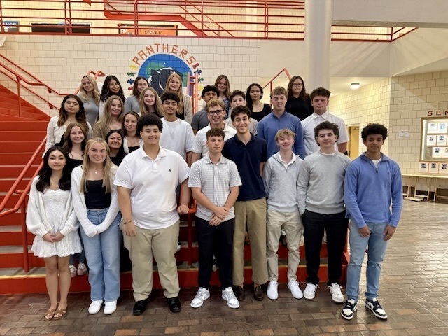 National Honor Business Society members pose for a group photo on a staircase at Marlborough High School.