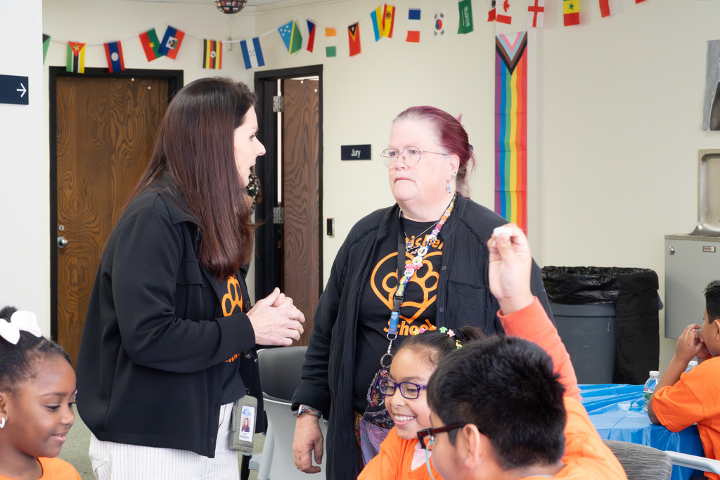 Richer School Principal Lisa Richards stands and chats with a staff member.