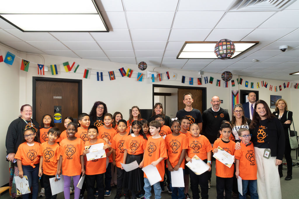 A group of Richer School students poses for a group photo with Judge Meghan Spring and school staff.