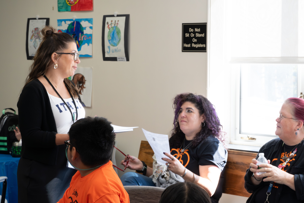 Probation Officer Ashley Losapio chats with two Richer School teachers.