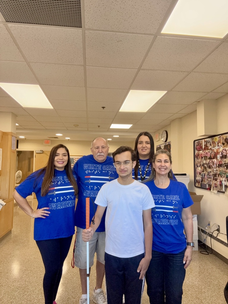 Four MPS staff members pose for a group photo with white cane user Benjamin Silva.