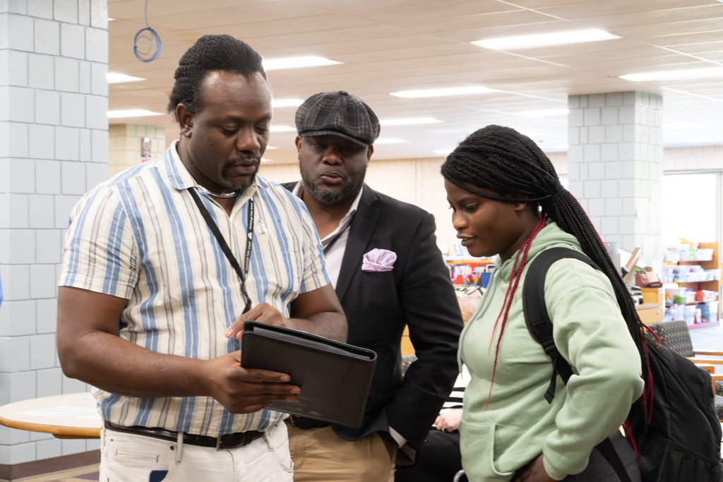 A Haitian Creole interpreter helps a student with paperwork during the 2025 MHS reality fair.