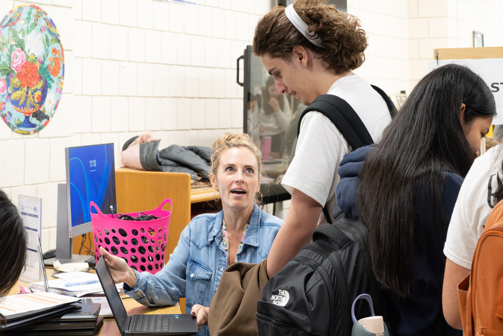 An MHS staff member helps a student during the 2025 Reality Fair.