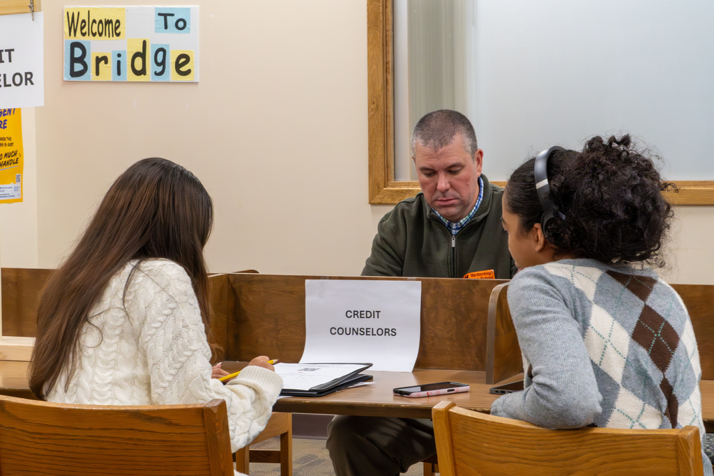 A volunteer credit counselor helps a student during the 2025 MHS Reality Fair.