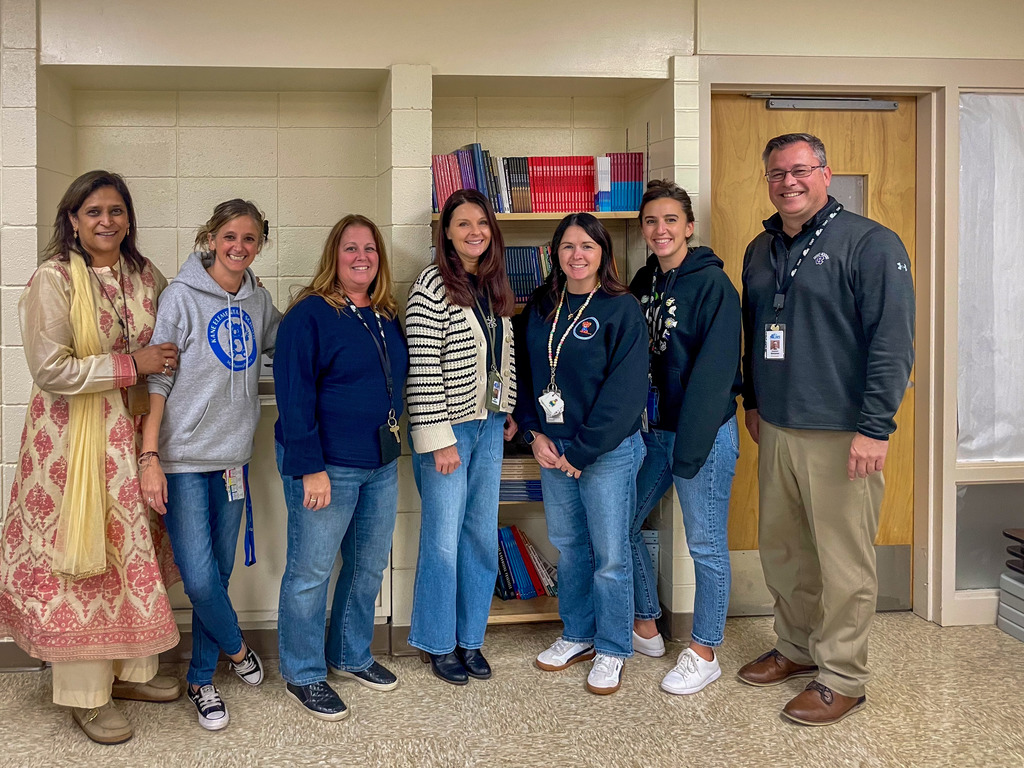 The seven MPS principals stand and pose for a group photo.