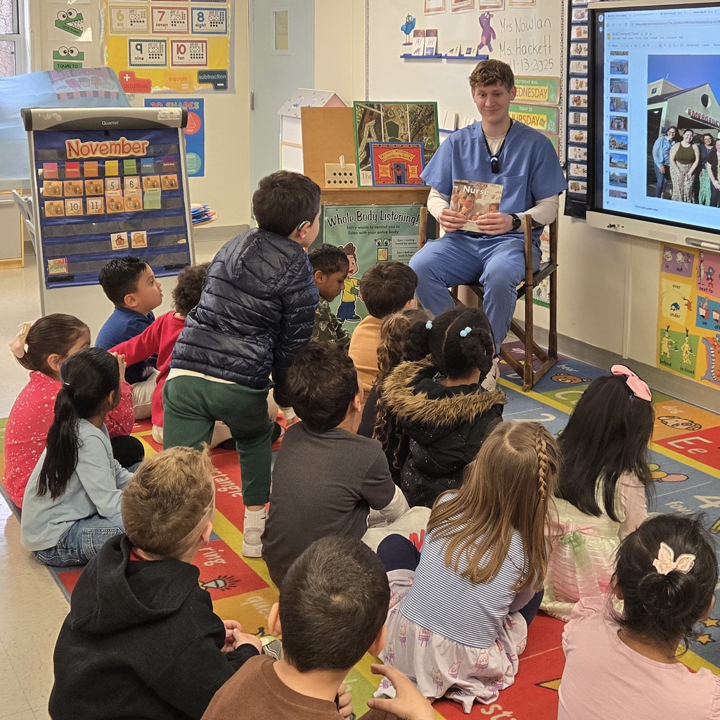A male nurse reads to a group of Richer Students.