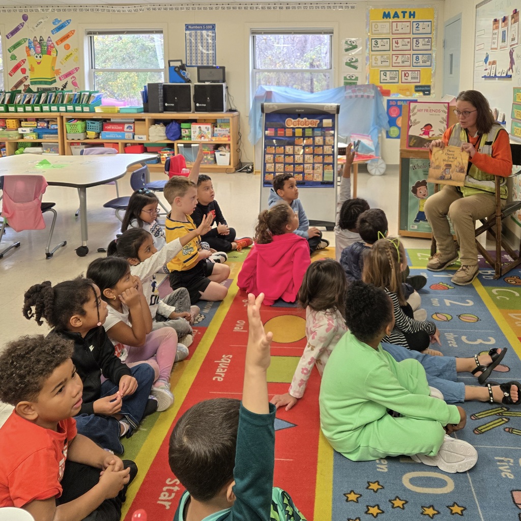 A guest reads to Richer School students.