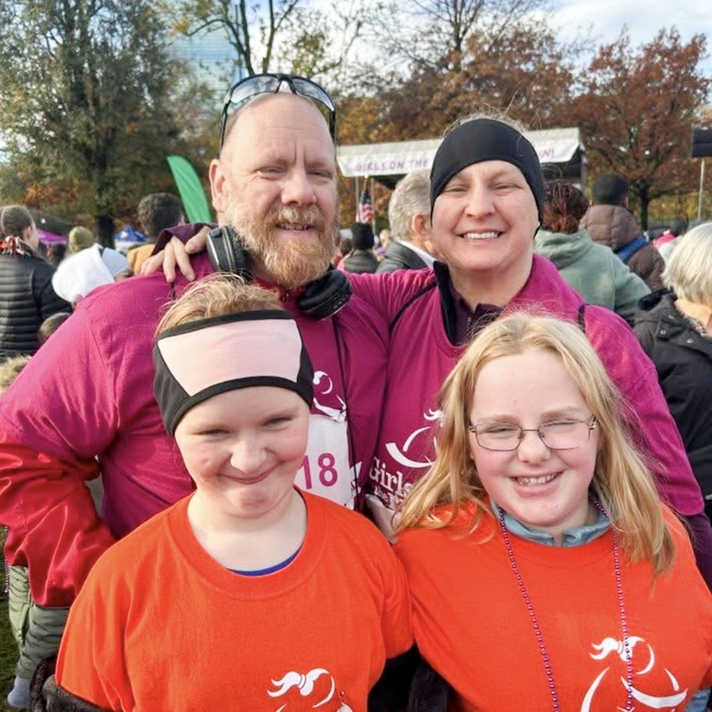 Two adults and two MPS girls pose for a photo.