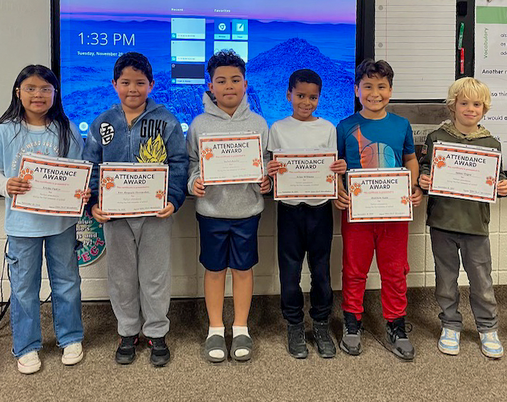 Six Richer Elementary School students pose with their perfect attendance award certificates.