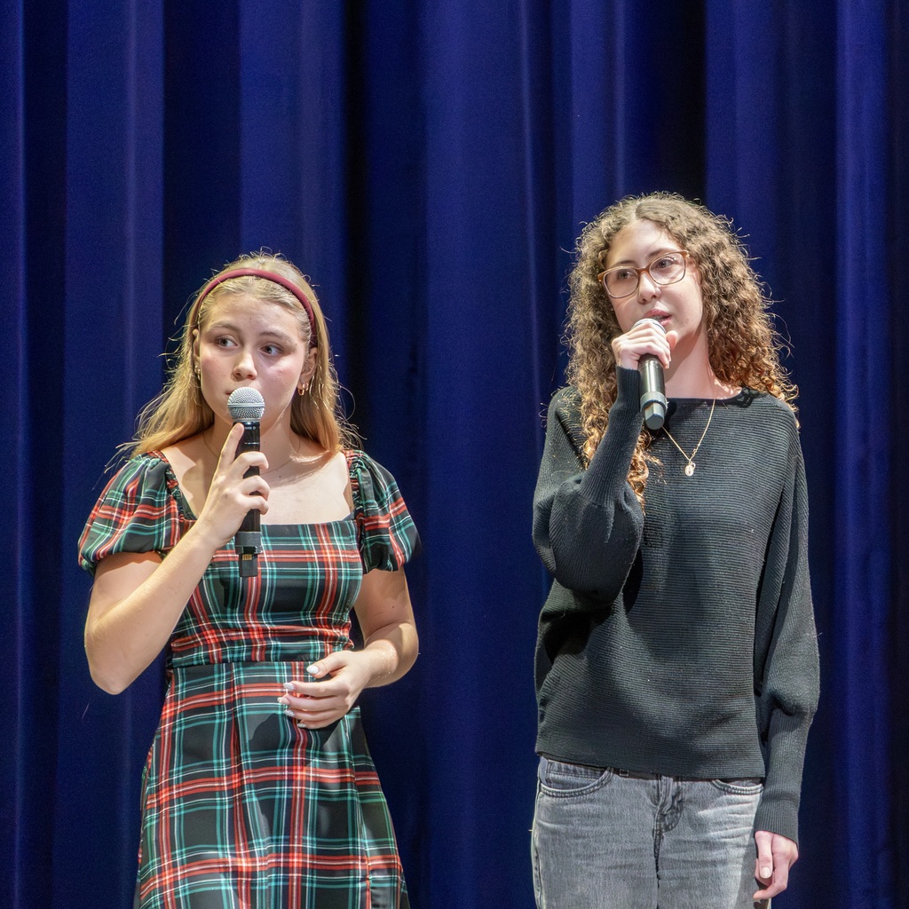 Two Fermata Nowhere members sing on stage. 