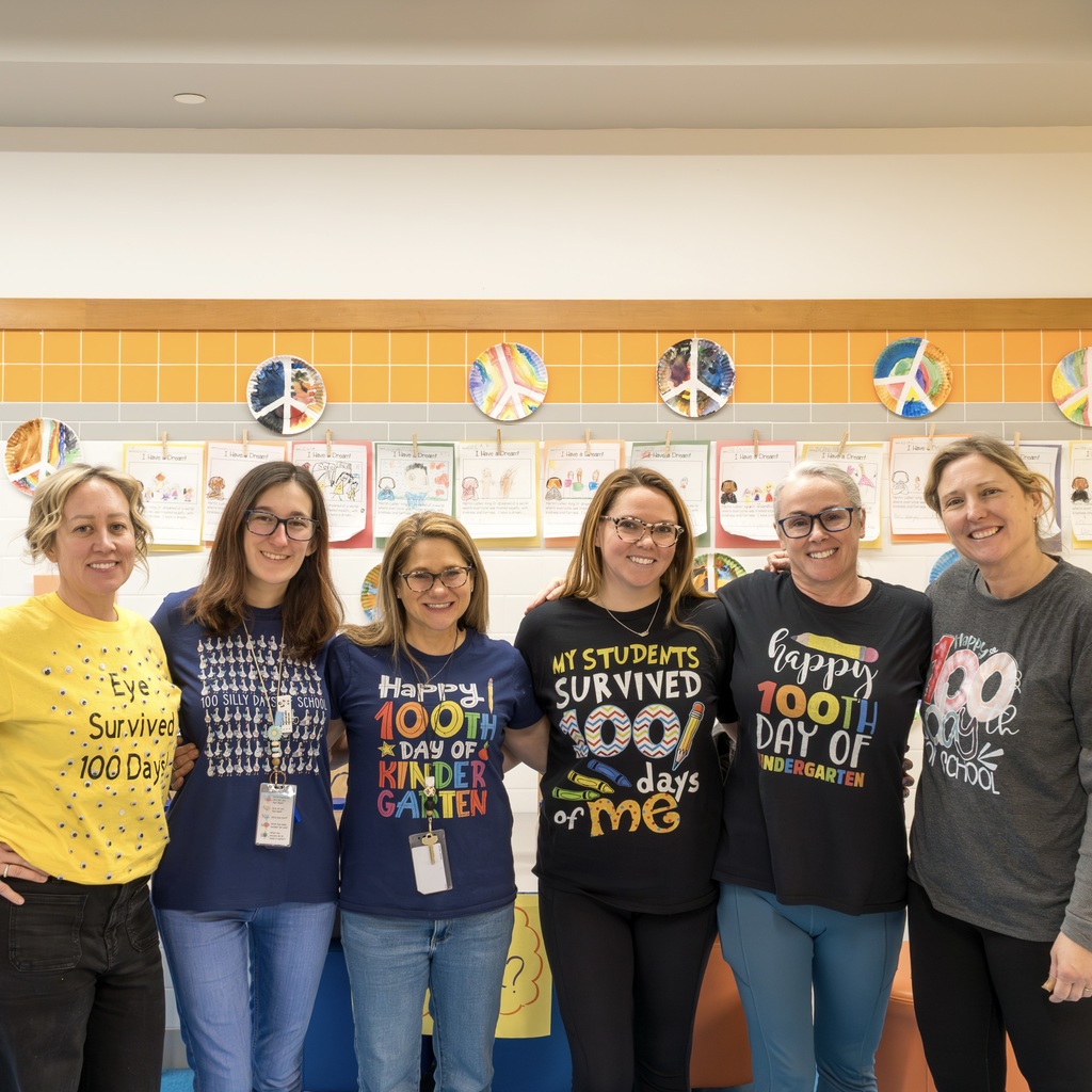 The Kindergarten team at Goodnow wearing 100th day of School themed shirts.