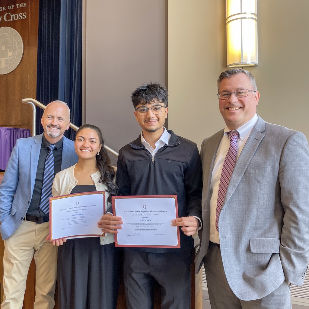 MPS Superintendent and MHS principal pose with two MHS seniors holding certificates.