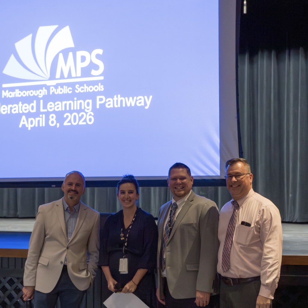 Four MPS staff members stand in front of a screen with text that reads Accelerated Learning Pathways, April 8, 2026 with the MPS logo.