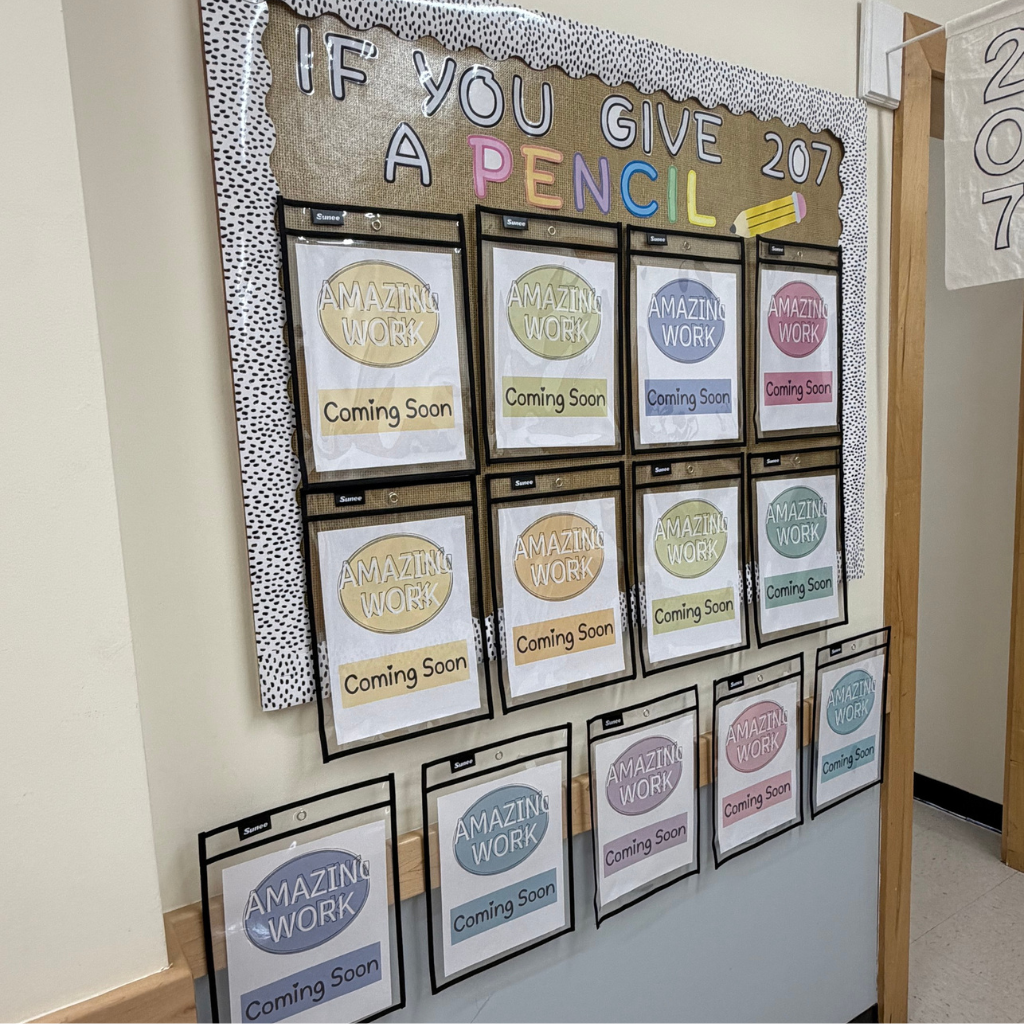Bulletin board with a banner saying "If you give a pencil". Many labels in various colors, one with "Amazing Work" and "Coming Soon".