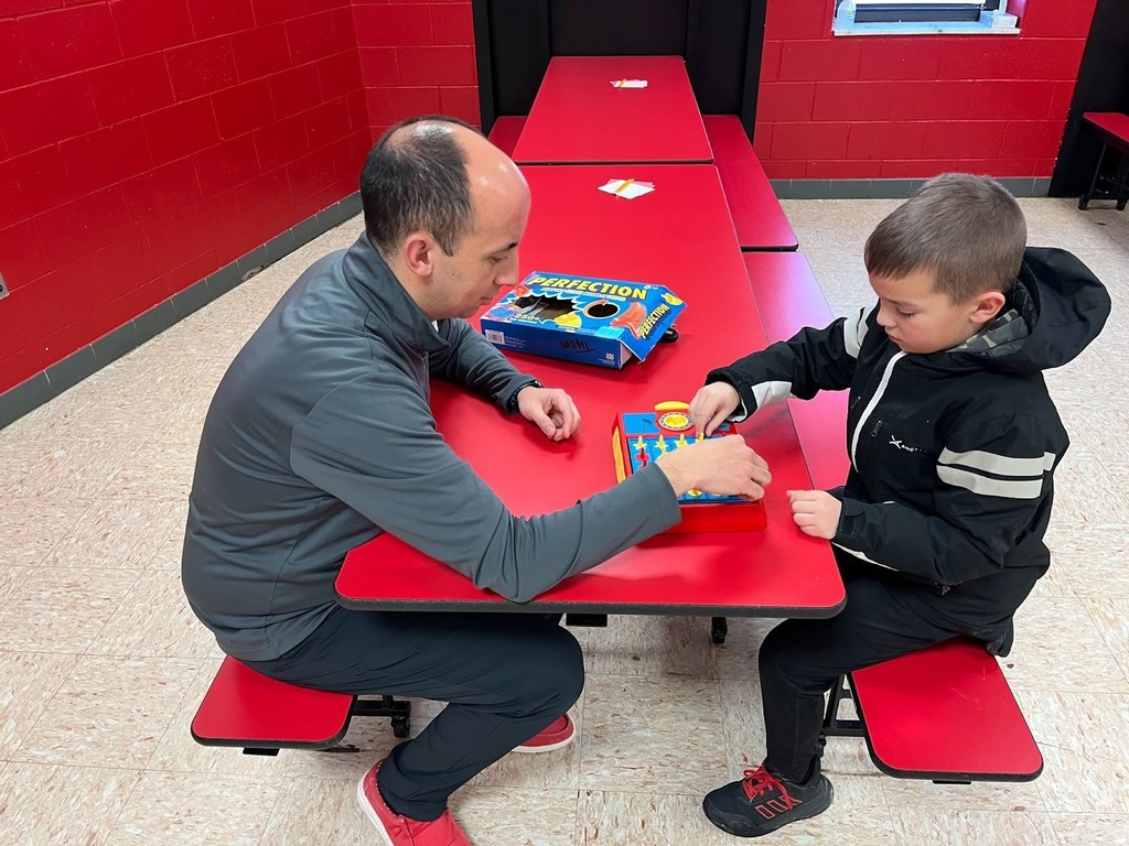 Principal Reynolds playing a game with a student