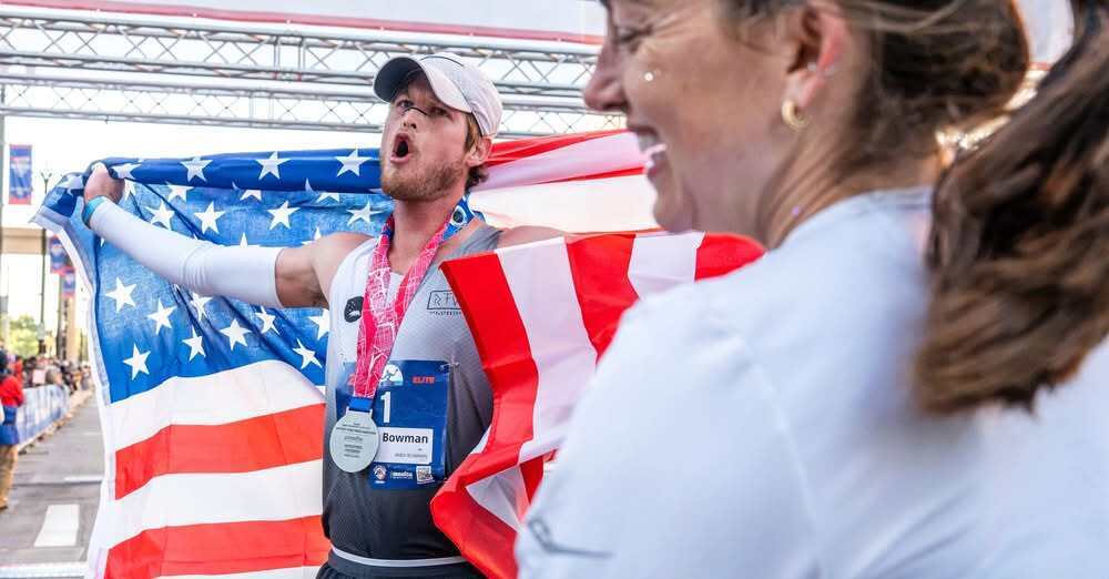 Andy Bowman, a Marlette Community Schools Alumni, holding an american flag and celebrating winning his 3rd consecutive Detroit Free Press Marathon!