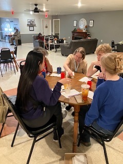 Students playing games with clients at Diane's Boarding Home 2.