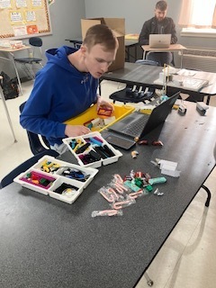 Students building robotic Legos