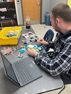 Students building robotic Legos
