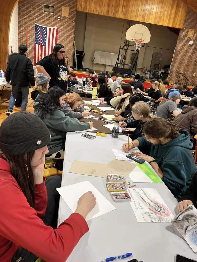 MAHS students painting art together in the gymnasium