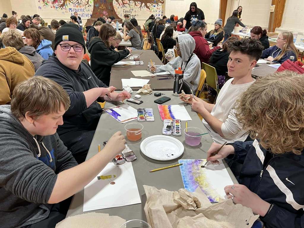 MAHS students painting art together in the gymnasium