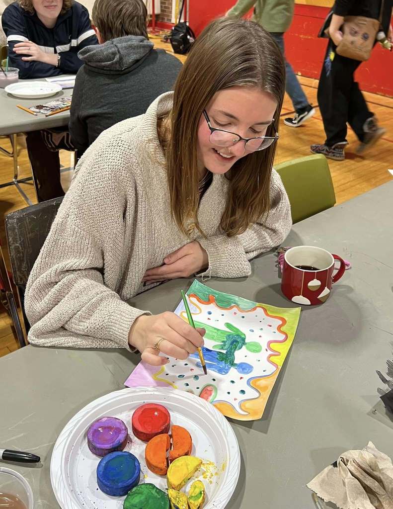 MAHS students painting art together in the gymnasium
