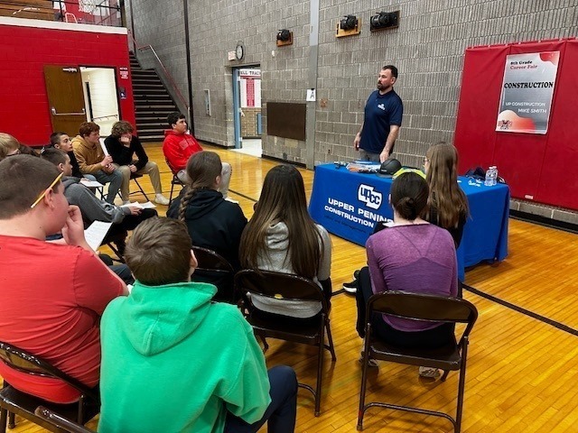 students listening to professionals talk about their jobs in the BMS gym