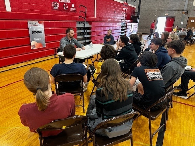students listening to professionals talk about their jobs in the BMS gym