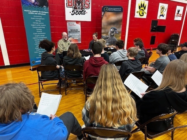 students listening to professionals talk about their jobs in the BMS gym
