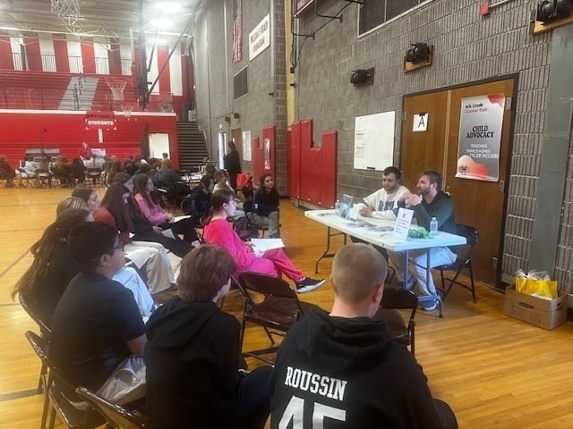 students listening to professionals talk about their jobs in the BMS gym