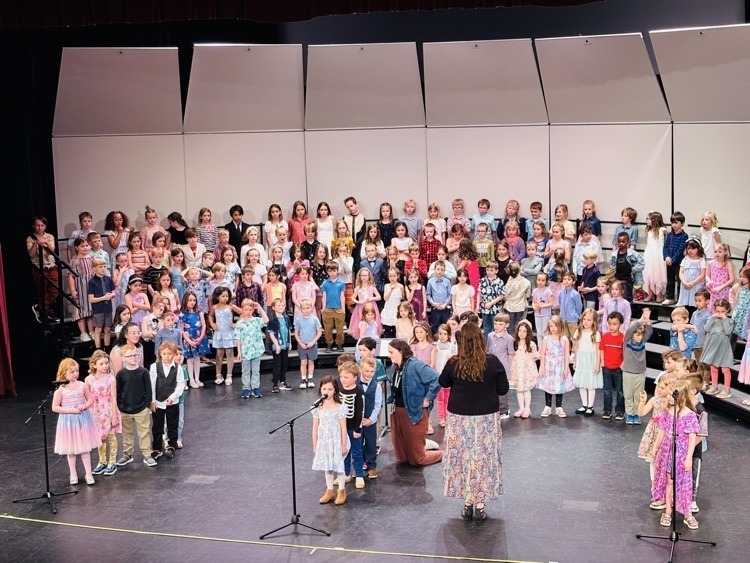 students singing and playing instruments at the concert