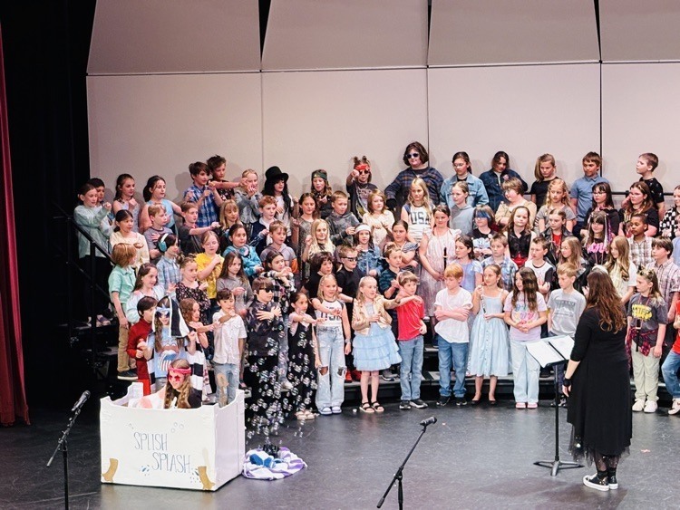 students singing and playing instruments at the concert