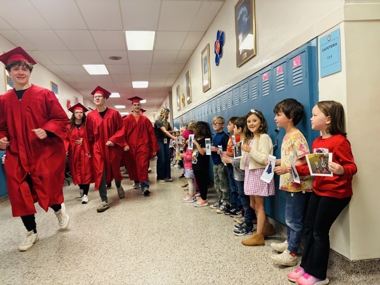 seniors high fiving students in the Graveraet halls
