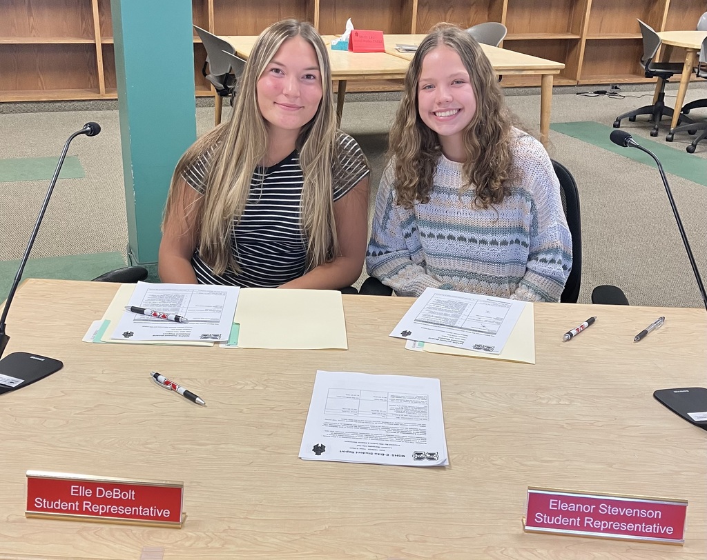the MSHS student representatives sitting at a desk.