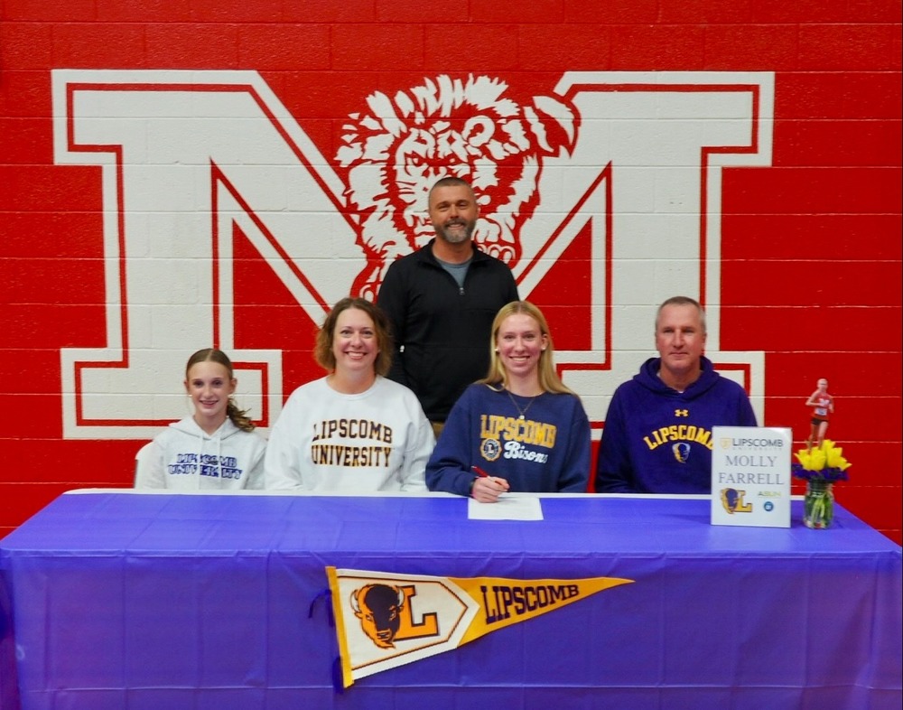 Molly Farrell signs her letter of intent to attend Lipscomb University and participate on the track and cross country teams