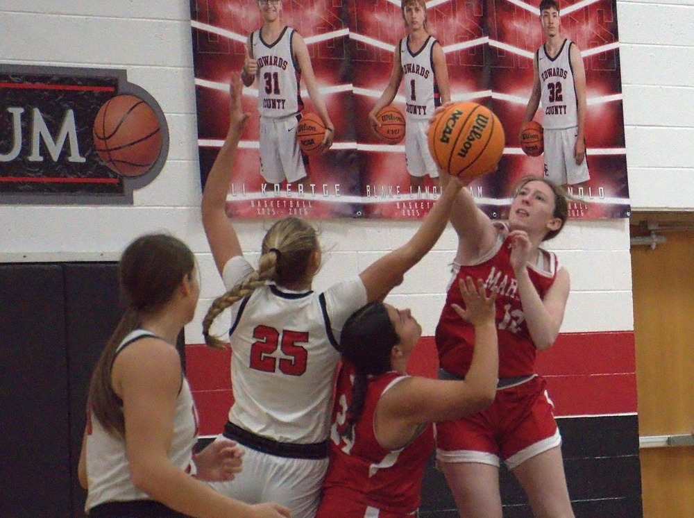 Marshall's Addy Ross (12) stuffs Edwards County's Lola Nussmeyer at the basket