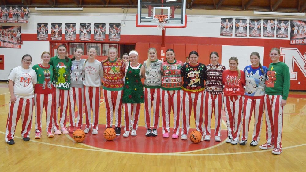 The girls basketball team dons their holiday sweaters for warm-ups