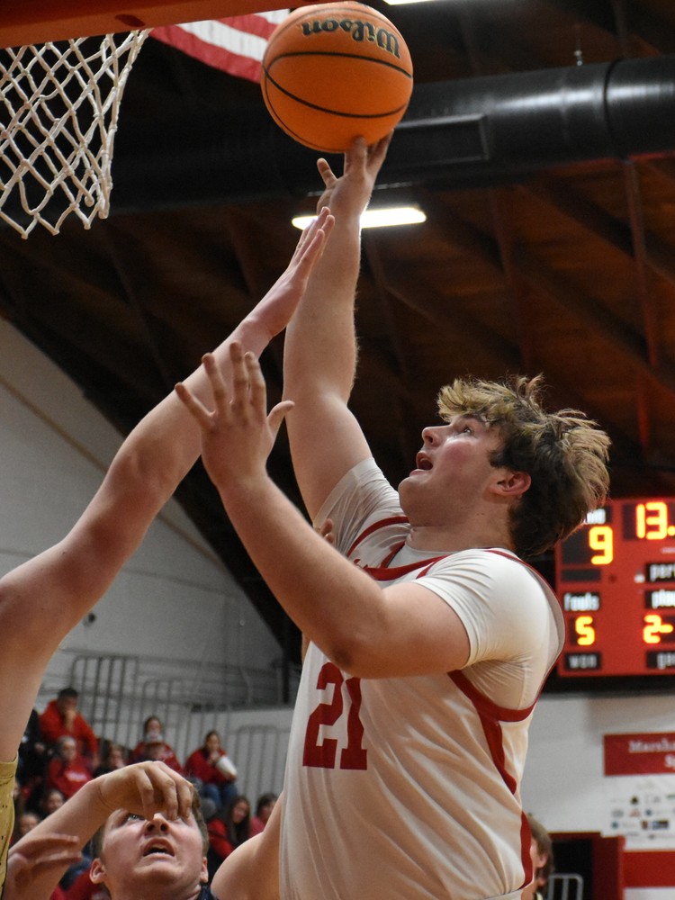 Garrett Pugh goes up high over the T-Town defense to score for Marshall (1)