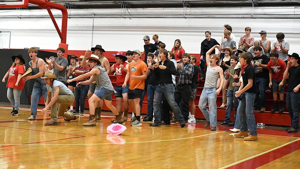 The Marshall student section erupts in jubilance after the Lions closed out the third and deciding set against Dieterich