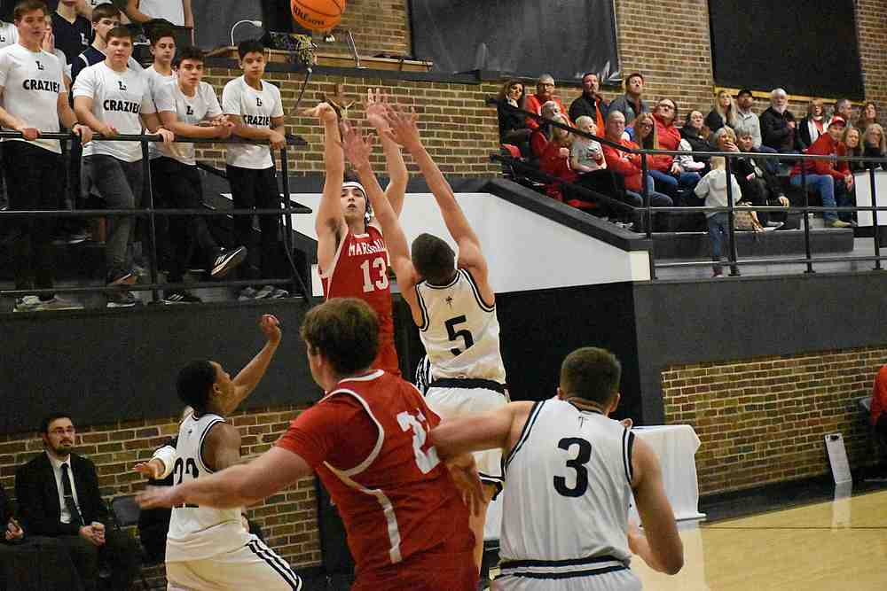 Payton McGuire (13) splashes a triple from the right wing against La Salette Academy