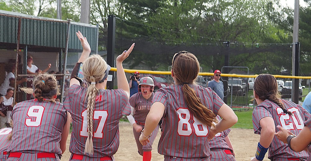 Lynn Welborn is greeted at home plate after her big blast against Robinson