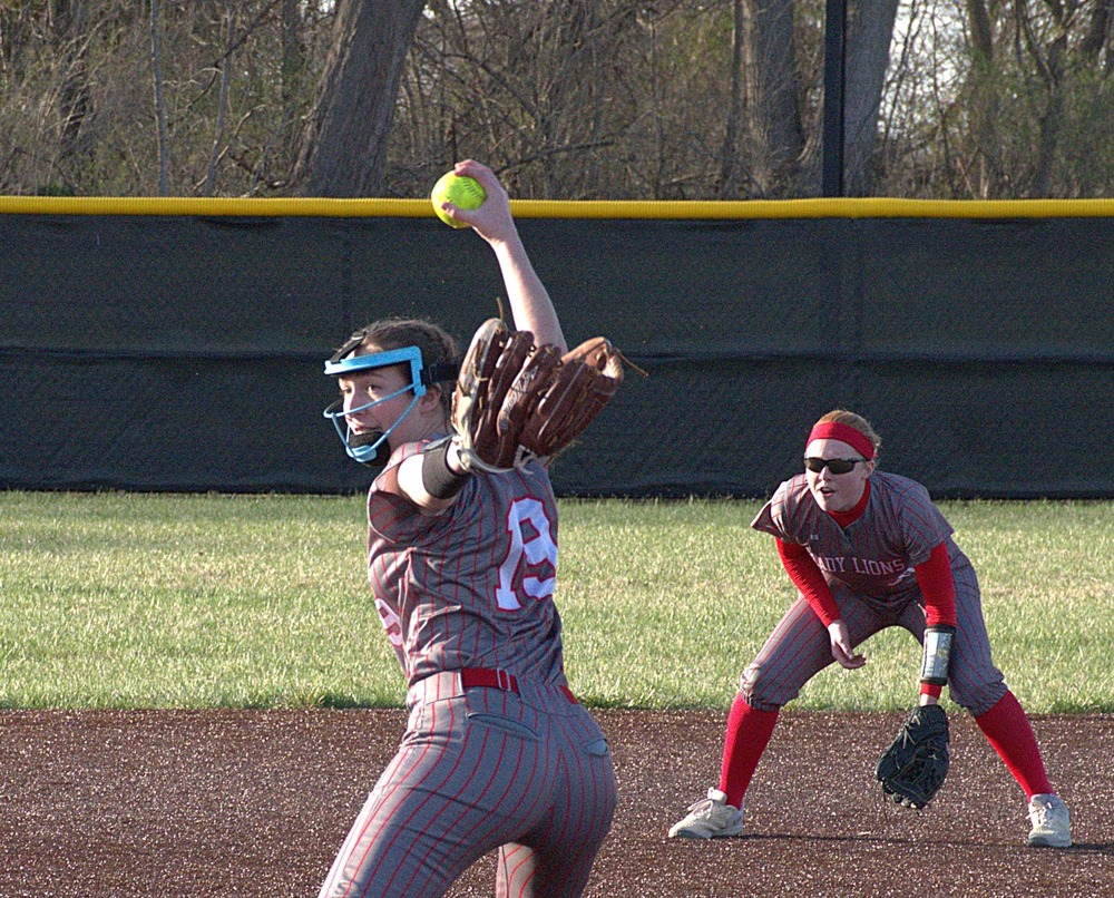 Mollie Kent (19) fires the final pitch as shortstop Lynn Welborn readies for a grounder which ended the game against Georgetown-Ridge Farm