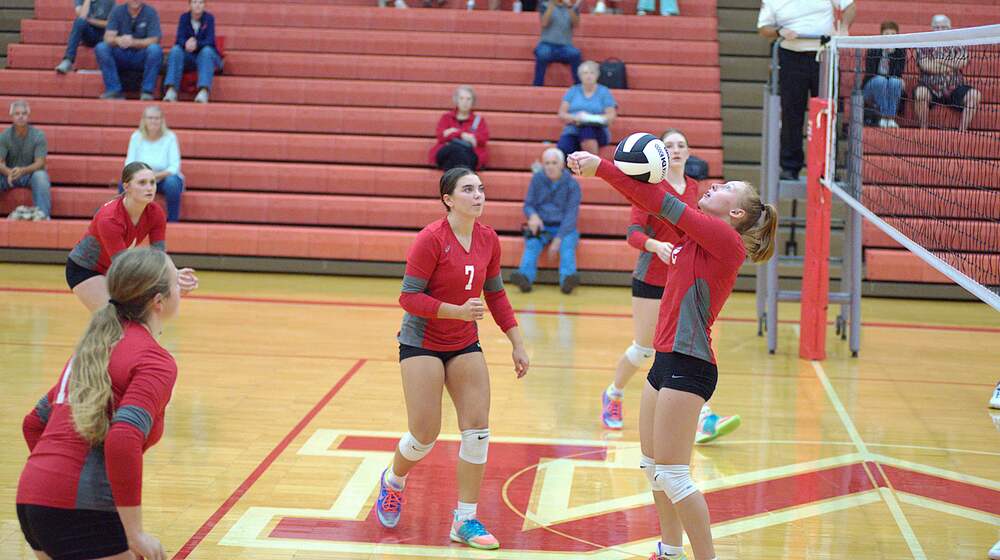 Aubree Shaffer (2) hits the ball backwards over the net to keep the point alive for Marshall