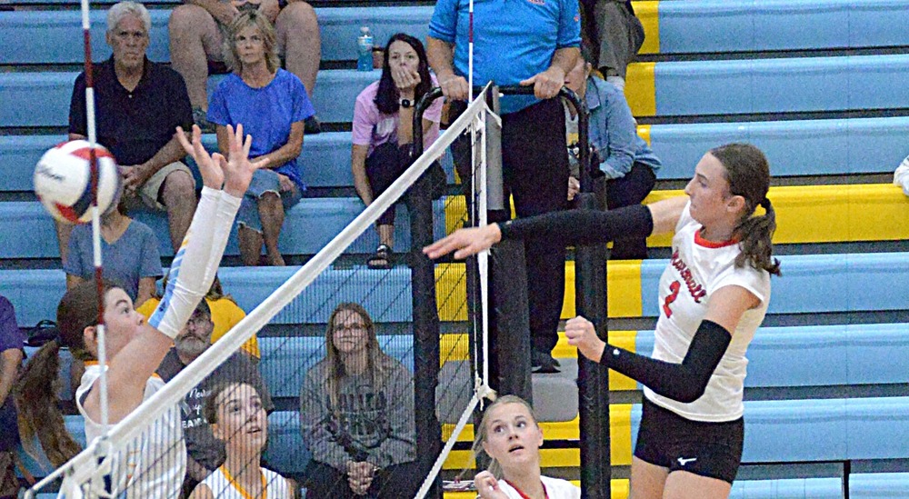 Lilly Ross (2) strikes the ball through the Cumberland block