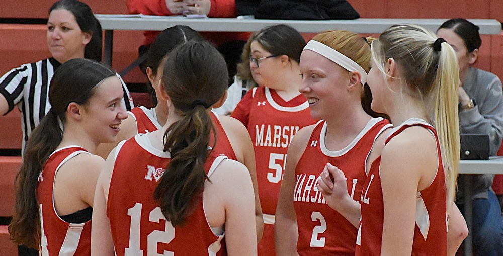 Marshall's starting five enjoy a moment before taking on Lawrenceville