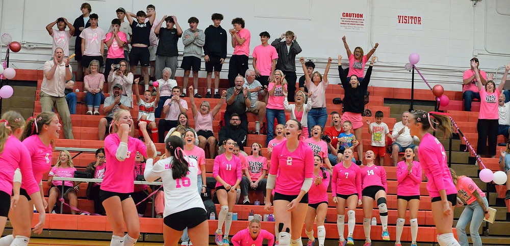 Marshall volleyball celebrates their comeback win in the third set against Paris as the Paris students stand in disbelief