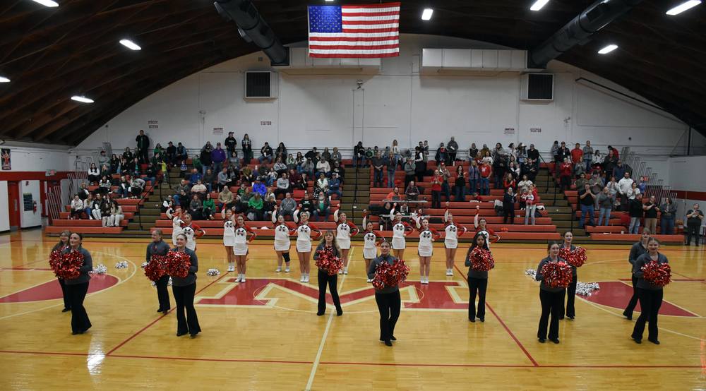 MHS Marshalettes and cheerleaders lead Lions fans during the school fight song